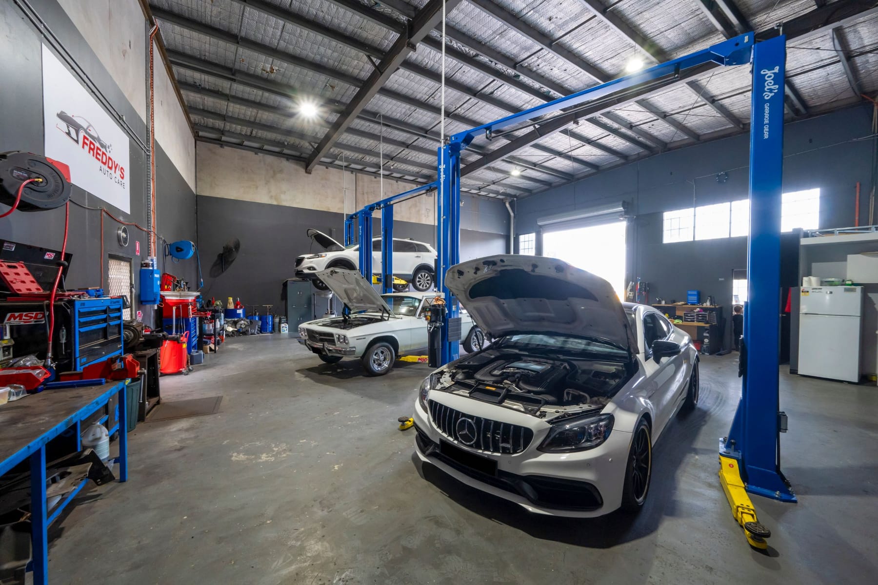 Inside the Freddy's Auto Care workshop in Craigieburn, with vehicles raised on hoists